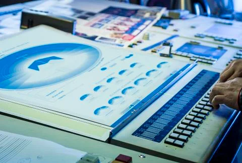 Young man in the process of offset printing and color correction Stock Photos