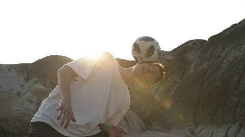 Young man professionally performs various tricks with a soccer ball Stock Footage 133509876