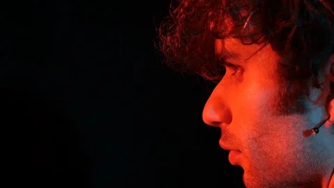 Young man profile with red light on black background	 Stock Footage 126857494
