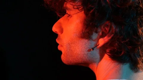 Young man profile with red light on black background	 Stock Footage 126857583