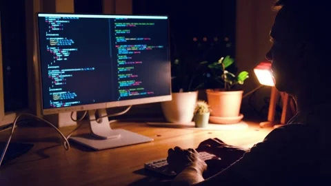 A young man programmer coding on a laptop Stock Footage 274096057