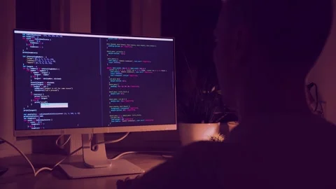 A young man programmer coding on a laptop Stock Footage 274096495
