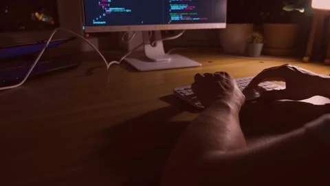 A young man programmer coding on a laptop Stock Footage 274096497