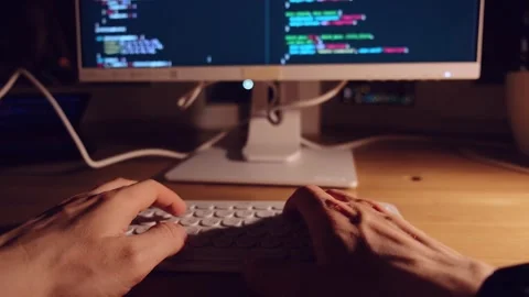 A young man programmer coding on a laptop Stock Footage 274096654