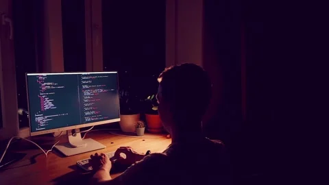 A young man programmer coding on a laptop Stock Footage 274096775