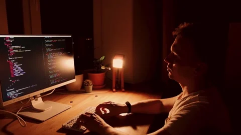 A young man programmer coding on a laptop Stock Footage 274096838