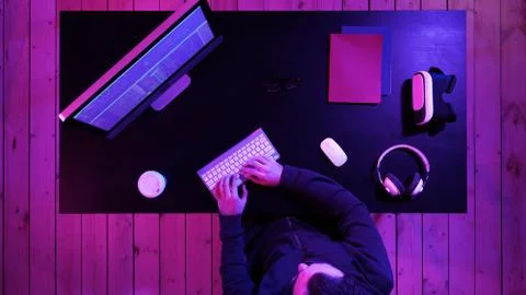 Young man programmer or hacker working on computer at night. 스톡 사진