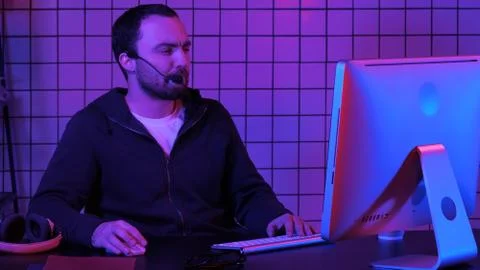 Young man programmer or hacker working on computer at night. 스톡 사진