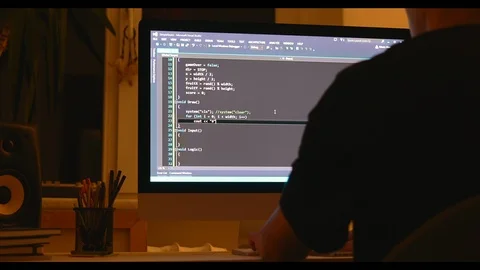 Young man programmer working at home in loft room writing programming code for Stock Footage 115491816
