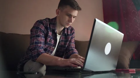 Young man programmer works at home at the computer. cozy room Stock Footage 212608194