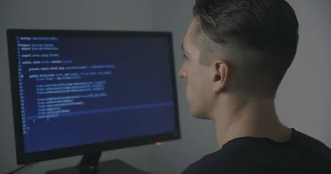 Young man programmer writing code while working at computer in office Stock Footage 95645216