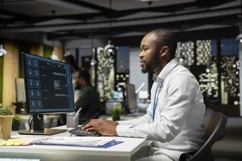Young man programming software code on his desktop computer 스톡 사진