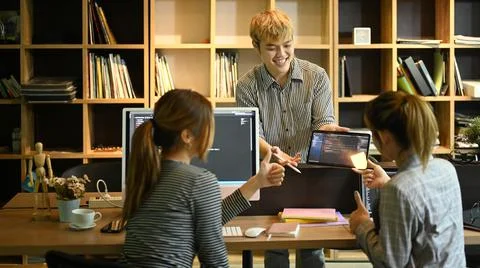 Young man project supervisor explaining detail of project developing website Stock Photos