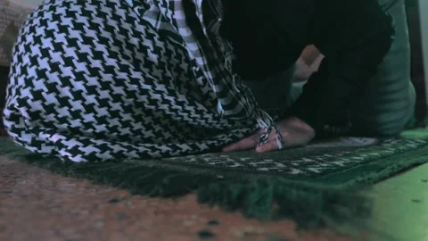 A young man prostrates during his prayer at home Stock Footage 299575531