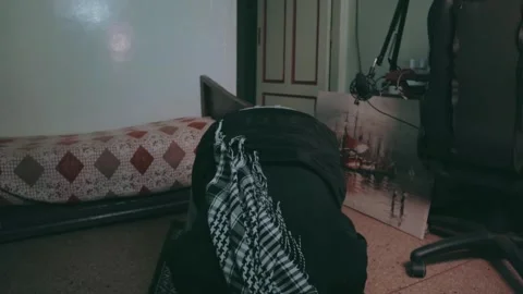 A young man prostrates during his prayer at home Stock Footage 299575547