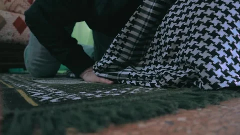 A young man prostrates during his prayer in a spiritual ritual. Stock Footage 299575944