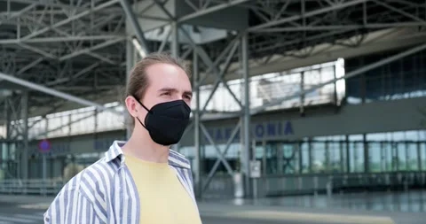 Young man with protective face mask outside the airport. Stock Footage 154000100