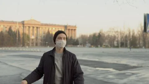 Young man in protective mask close up, portrait empty street area Stock Photos