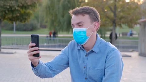 Young man in protective mask communicates online via video call Stock Footage 140737170