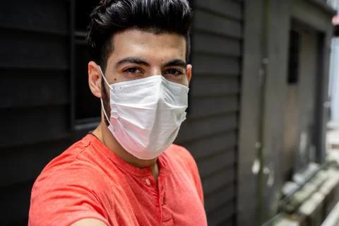 Young man with a protective mask making a selfie Stock Photos