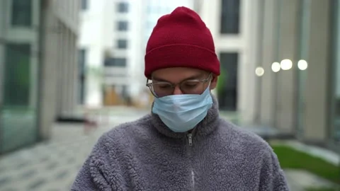 A young man in a protective mask man with beautiful smile and hipster millennial Stock Footage 130878895