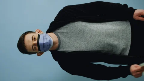 Young Man in Protective Mask Is Urging to Keep Calm Stock Footage 128515369