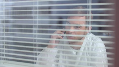 Young man in protective workwear talk on phone and laugh in the laboratory Stock Footage 123671650