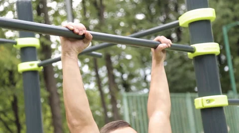 Young man pull ups bars workout exercise Stock Footage 66431070