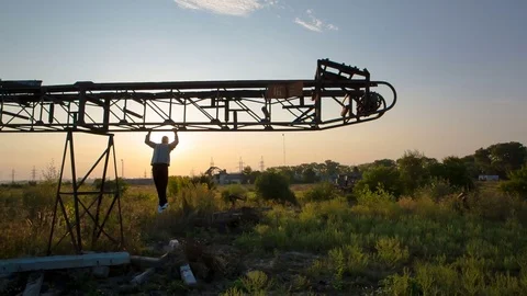 Young man pull ups on a horizontal metal arrows in the open air. Training in the Stock Footage 79442394