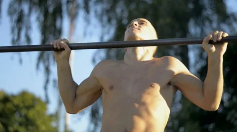 The young man pulled on a horizontal bar Stock Footage 67483812