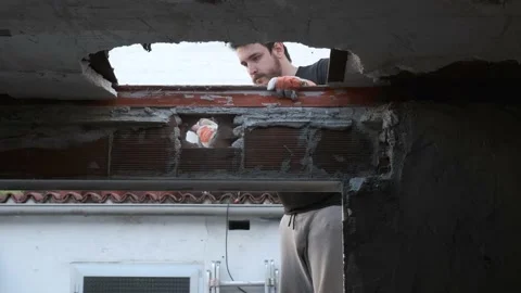 Young man pulling the ceiling of a house down. Stock Footage 196386521