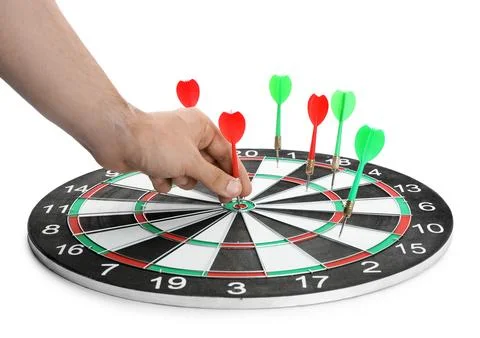 Young man pulling dart out of board on white background, closeup Stock Photos