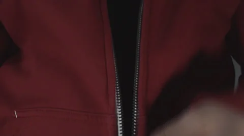 Young Man Pulling Down A Zipper On A Red Shirt Front-Shot Stock Footage 36824184