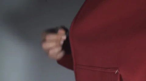 Young Man Pulling Down A Zipper On A Red Shirt Side-Shot Stock Footage 36824226