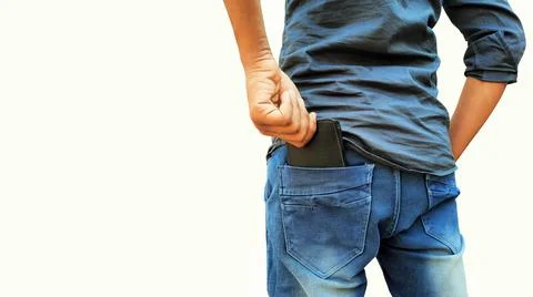 Young man pulling out wallet from back pocket of jeans isolated on white Stock Photos