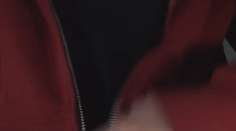Young Man Pulling Up A Zipper On A Red Shirt Front-Shot Stock Footage 36824177