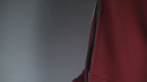 Young Man Pulling Up A Zipper On A Red Shirt Side-Shot Stock Footage 36824217