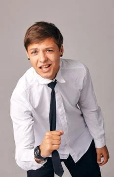 A young man pulls himself by his tie, he is tired of office work Stock Photos