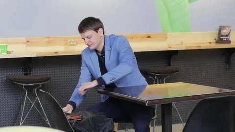 The young man pulls out a backpack laptop Stock Footage 73966587