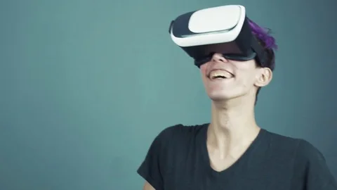 Young man with purple bangs using vr glasses doing gestures looking around close Stock Footage 70059237