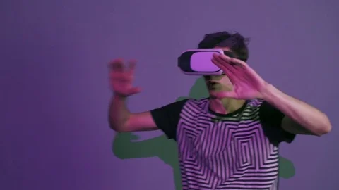 Young man with purple bangs using vr glasses doing gestures looking around Stock Footage 70062144