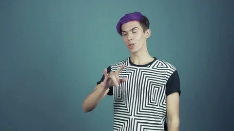 Young man with purple bangs using vr glasses headset doing gestures looking Video stock 70810425