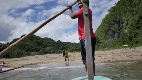 Young Man Pushes Outrigger Canoe Off Shore Departing Stock Footage 219842183