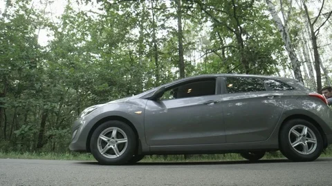 Young Man Pushing his Car Seen From the Side Stock Footage 79744351