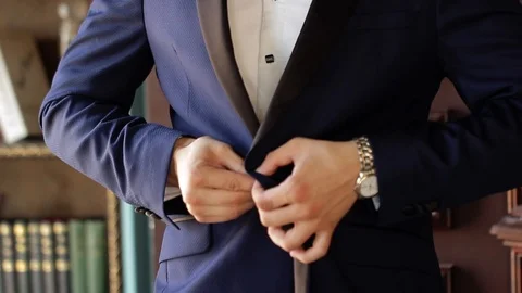 Young man put on classical suit blue jacket Stock Footage 93847563