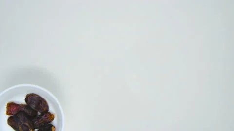 A young man put a dates or kurma. Isolated on white background. copy space. 4 Stock Footage 147502847