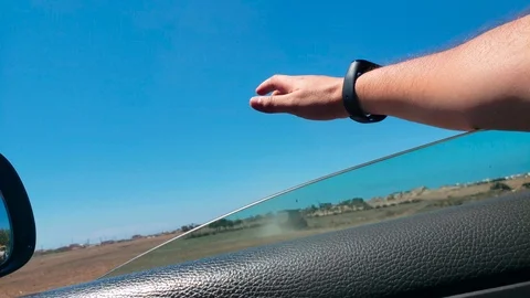 A young man put his hand out of the car window Stock Footage 114190990