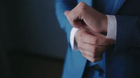 Young man put on jacket. Dressing for celebration event, business meeting or Stock Footage 130372646