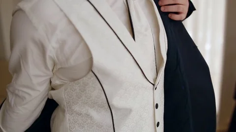 Young man put on the jacket Stock Footage 79789940