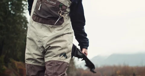 Young man put pack on while fly fishing Stock Footage 102188165